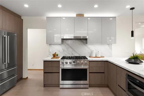 a kitchen with a stove and a refrigerator