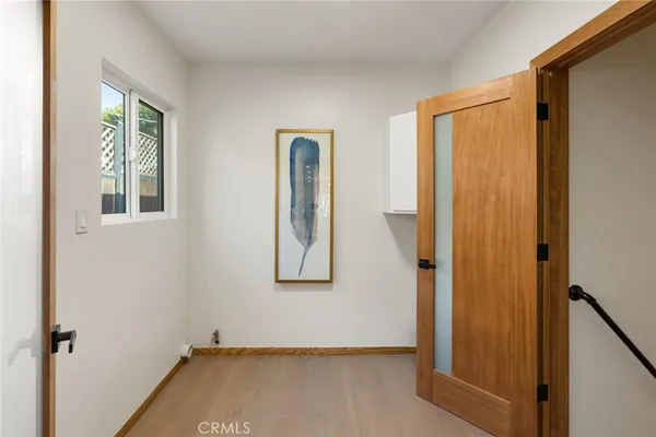 a view of a room with wooden floor and windows