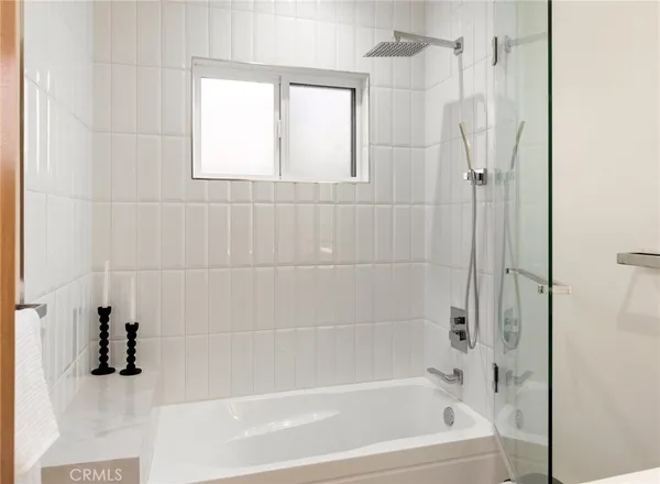 a bathroom with a shower and a bath tub