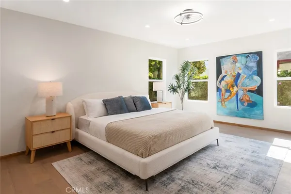 a bedroom with a bed and wall painting