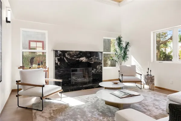 a living room with furniture a rug and a fireplace