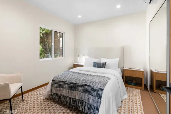 a bedroom with a bed a table and chair