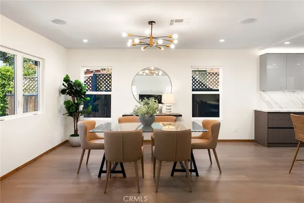 a view of a dining room with furniture window and wooden floor