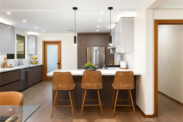 a dining room with furniture a window and kitchen view
