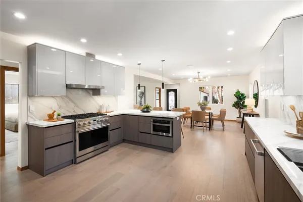a view of kitchen with sink and stainless steel appliances