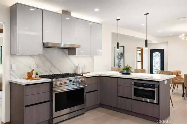 a kitchen with a stove sink and refrigerator