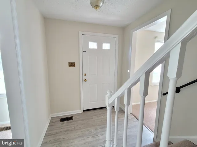a view of entryway with wooden floor