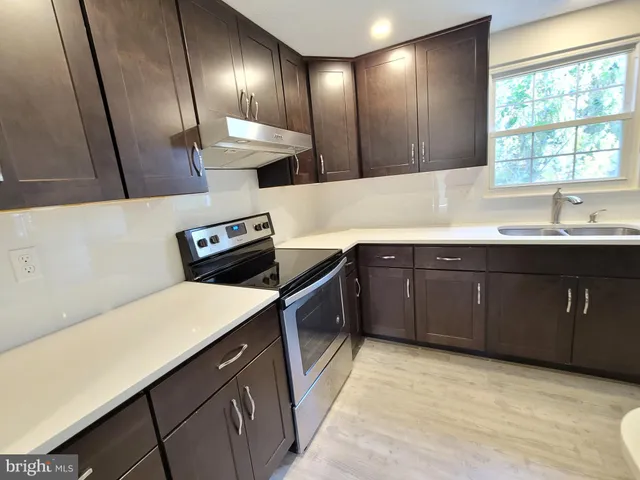 a kitchen with a sink and stove