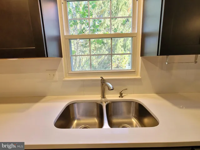 a kitchen with a sink and washing machine