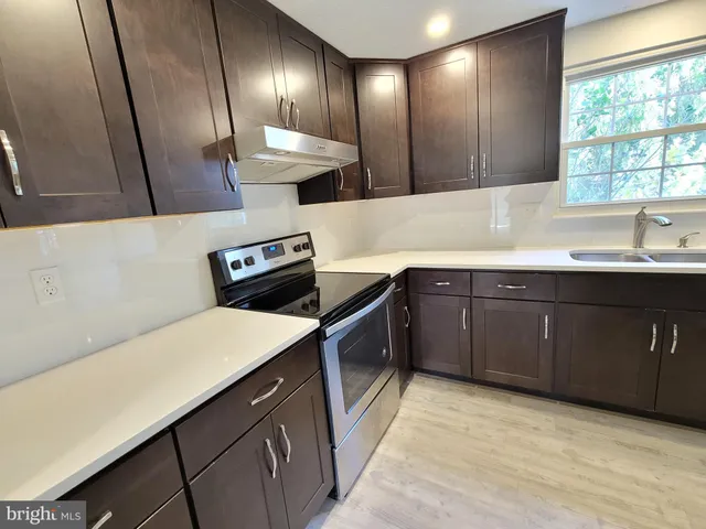 a kitchen with a sink and stove