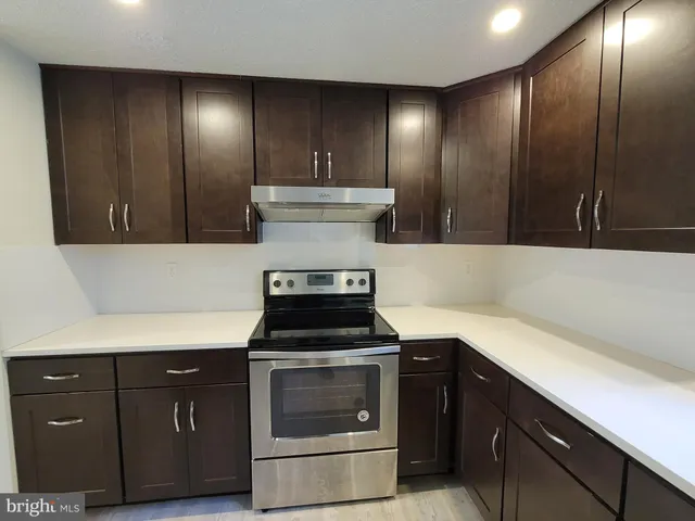 a kitchen with a stove and a cabinets