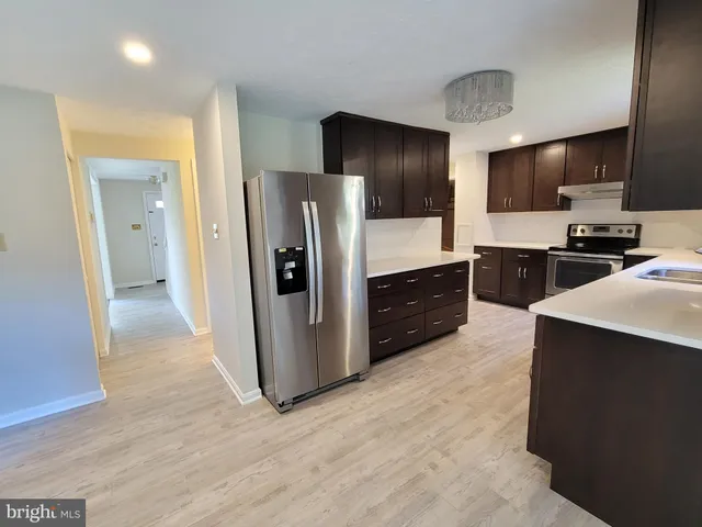 a kitchen with stainless steel appliances a refrigerator and a stove