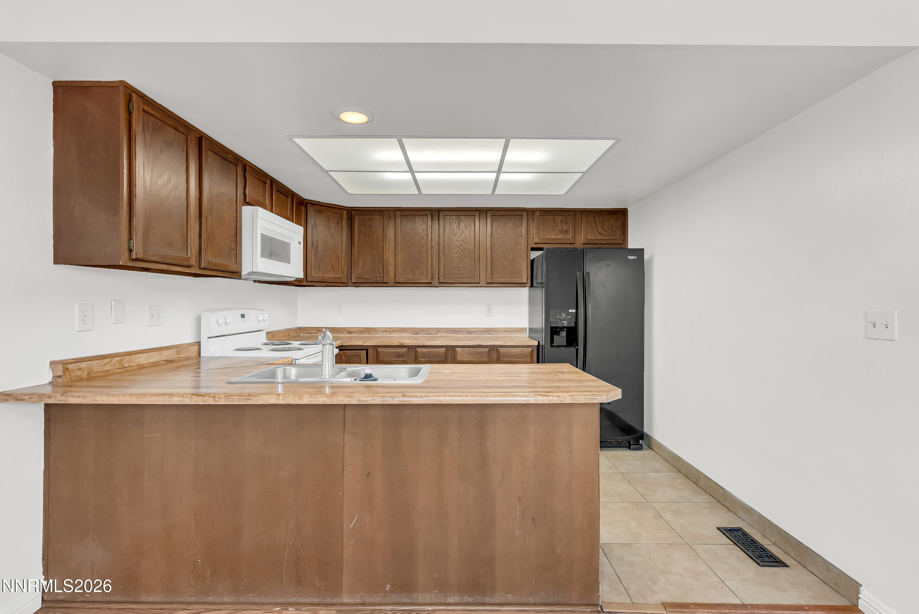 1045 Hartford Court Reno, NV 89503 - Photo 11 of 36 a kitchen with stainless steel appliances granite countertop a sink stove and refrigerator
