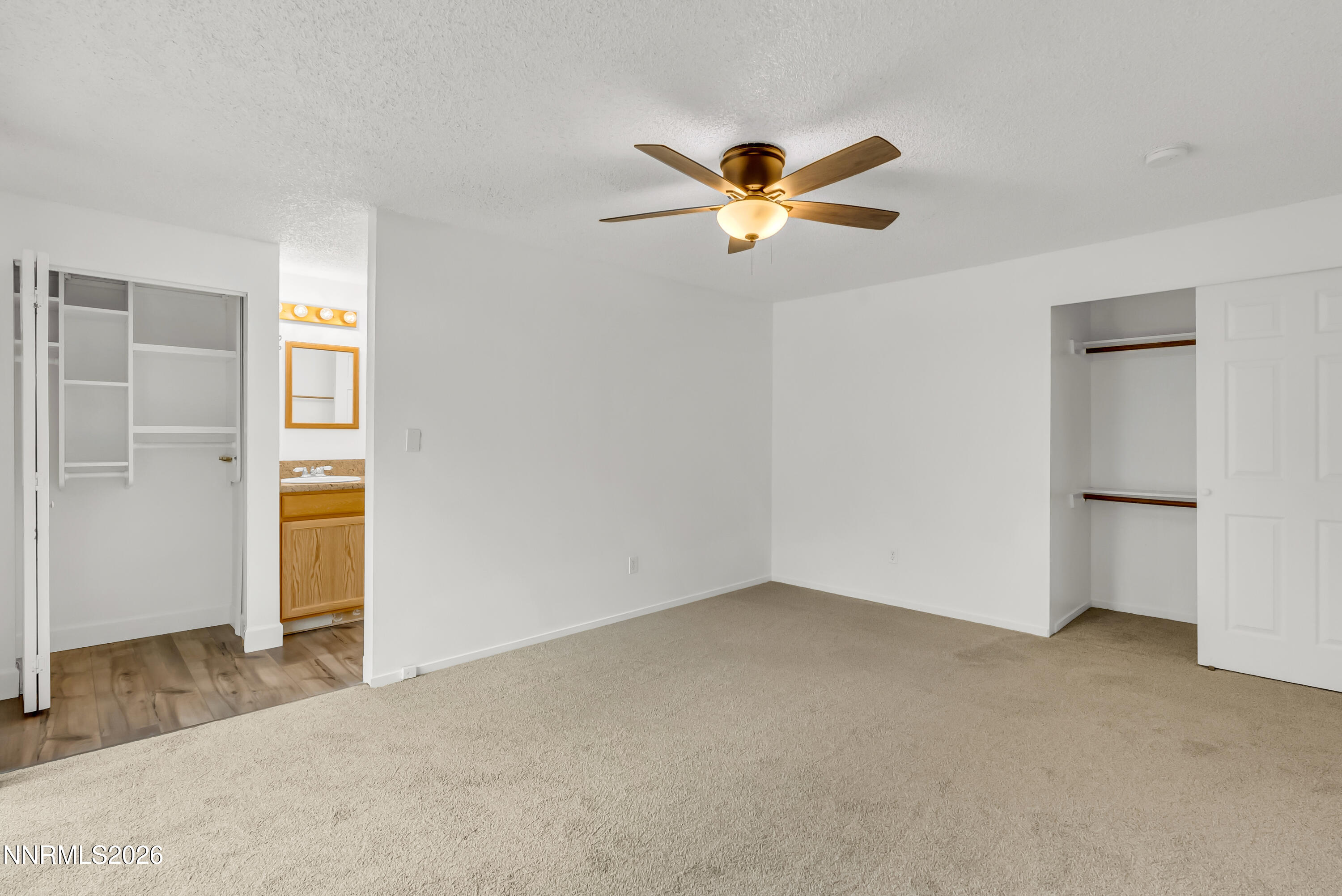 1045 Hartford Court Reno, NV 89503 - Photo 14 of 36 a view of a room with a ceiling fan and carpet