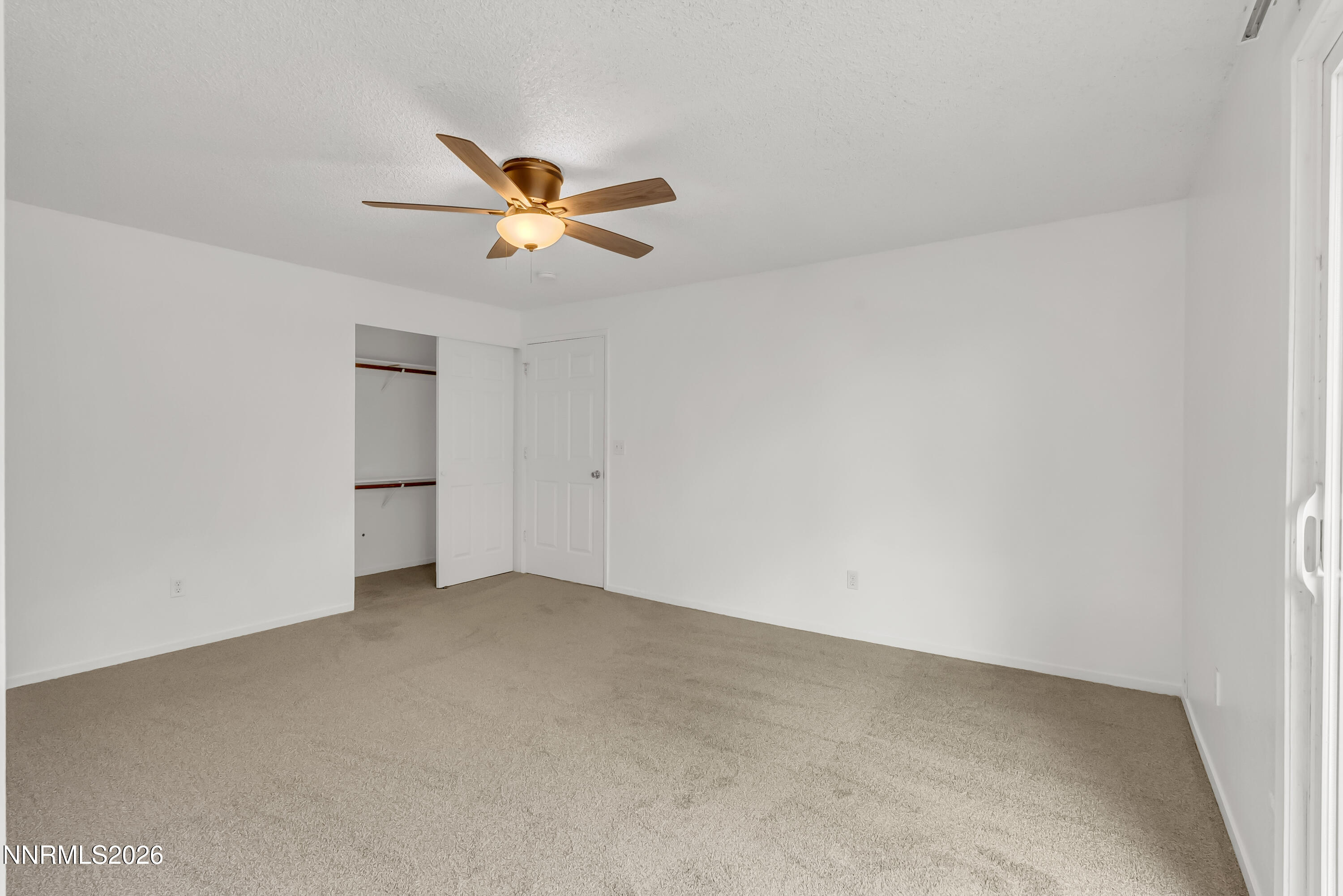 1045 Hartford Court Reno, NV 89503 - Photo 15 of 36 an empty room with a ceiling fan and window
