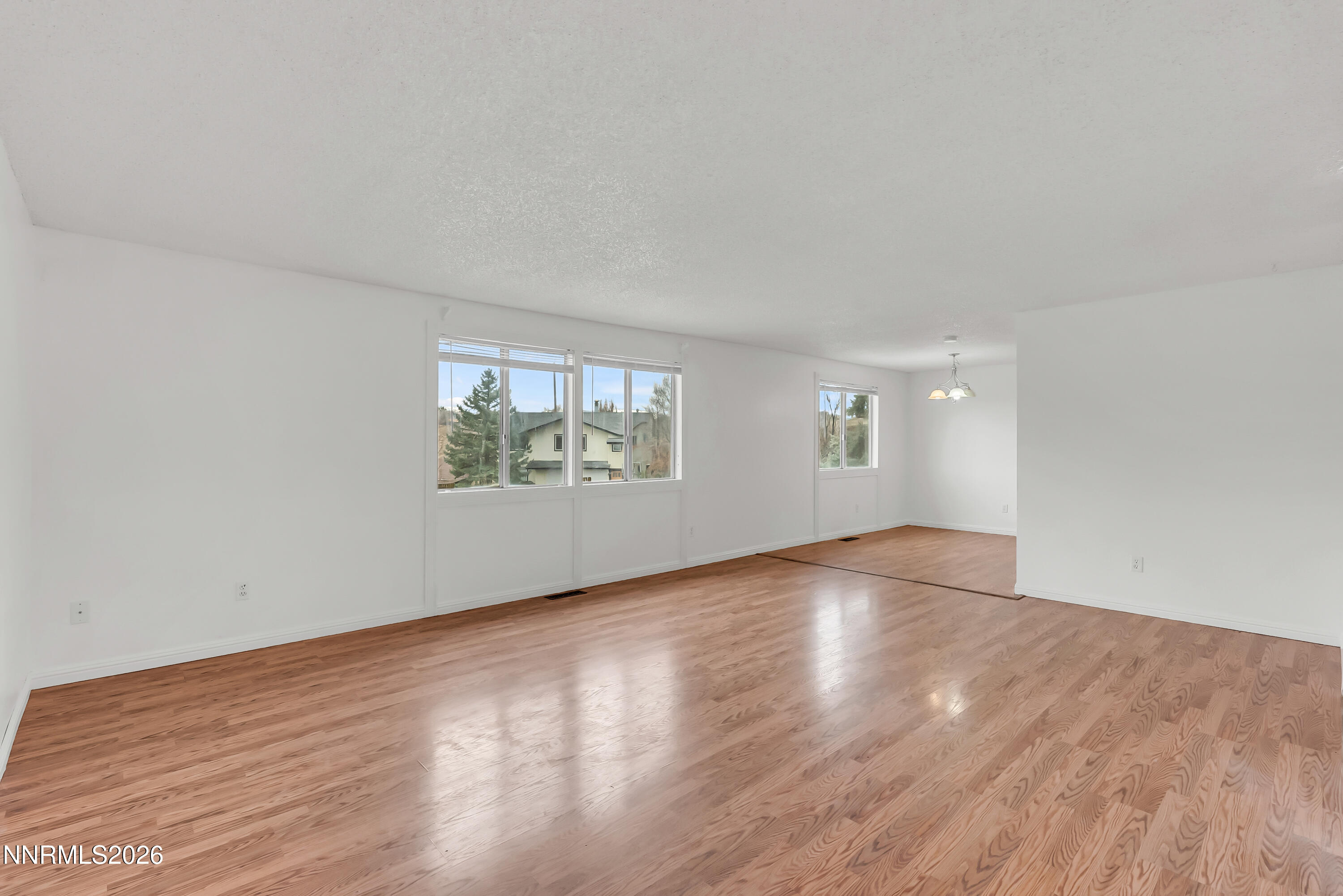 1045 Hartford Court Reno, NV 89503 - Photo 7 of 36 an empty room with wooden floor and windows