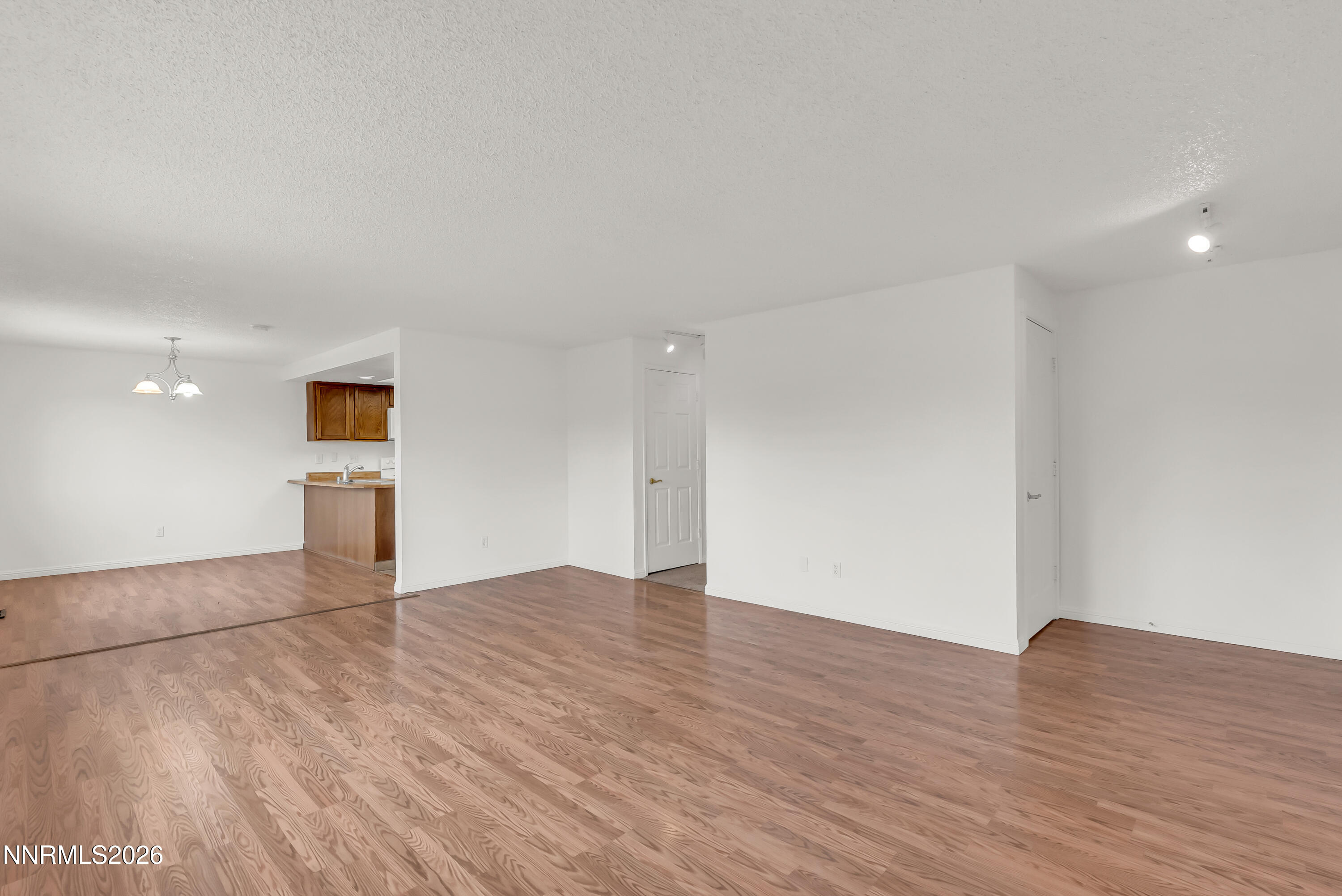 1045 Hartford Court Reno, NV 89503 - Photo 8 of 36 a view of an empty room with wooden floor and a window