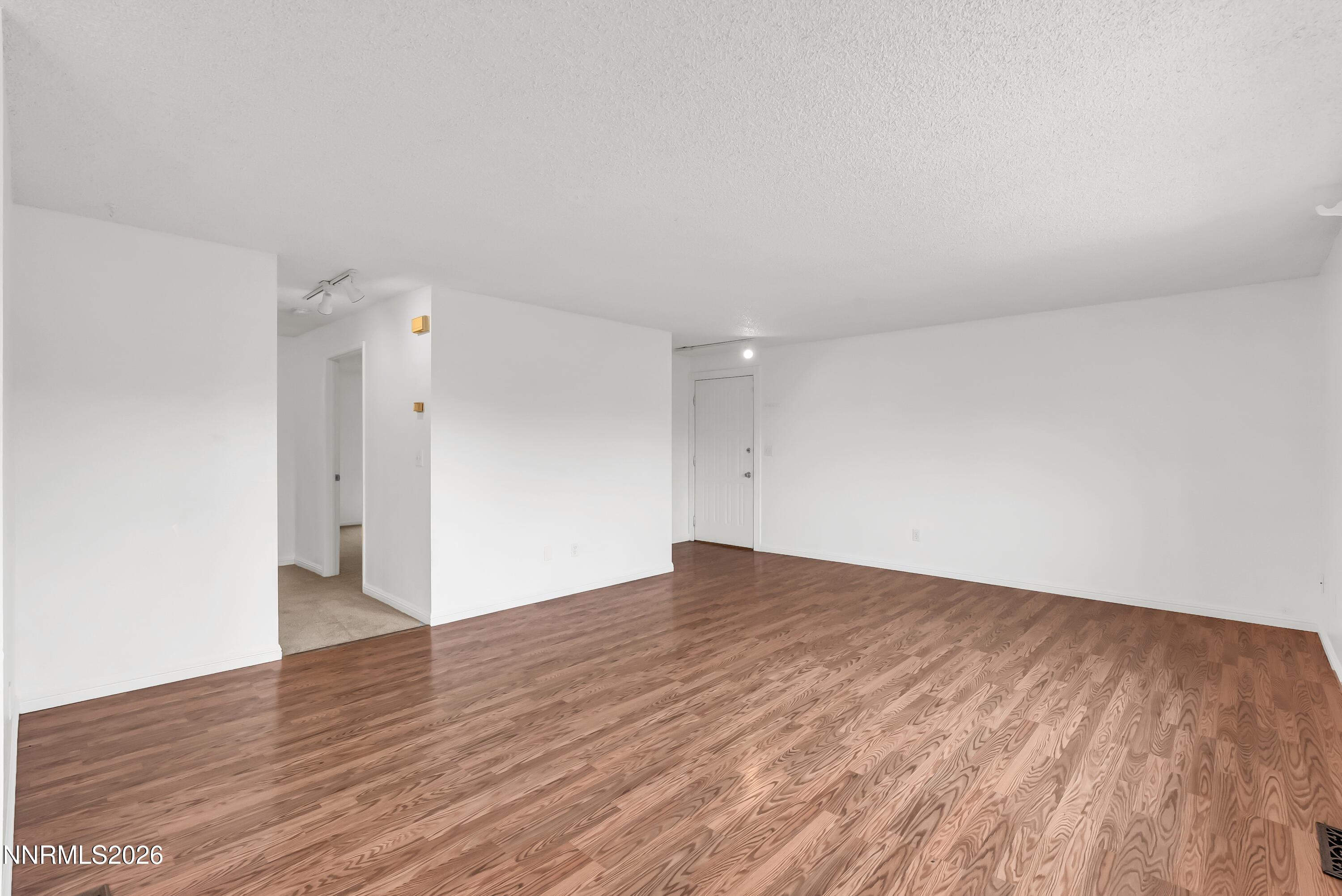 1045 Hartford Court Reno, NV 89503 - Photo 9 of 36 a view of an empty room with wooden floor