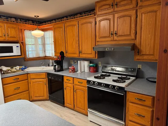 a kitchen with stainless steel appliances granite countertop a stove and a microwave
