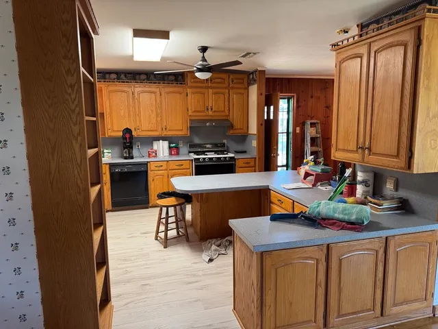 a kitchen with a sink appliances and cabinets