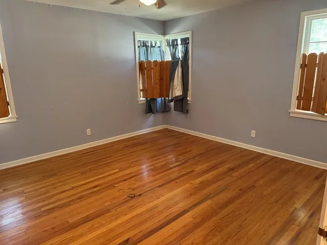 a view of a room with wooden floor and stairs
