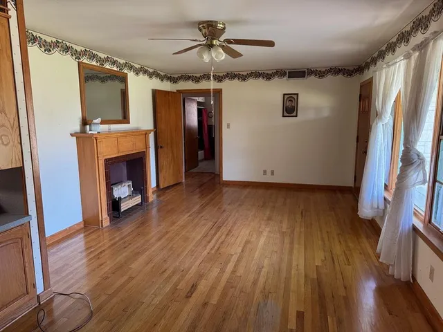 a view of livingroom with hardwood floor and a ceiling fan