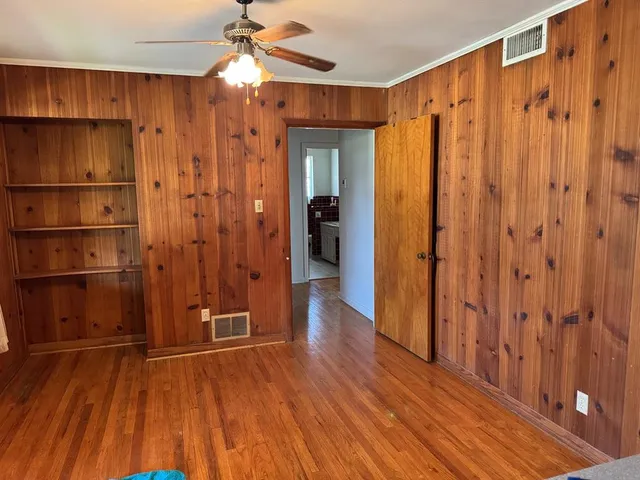 a view of a hallway with wooden floor and entryway