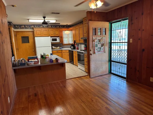 a view of a living room with wooden floor