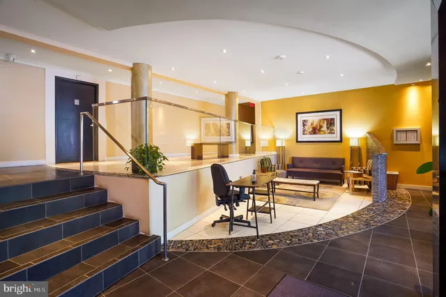 a living room with furniture a dining table and chairs with wooden floor