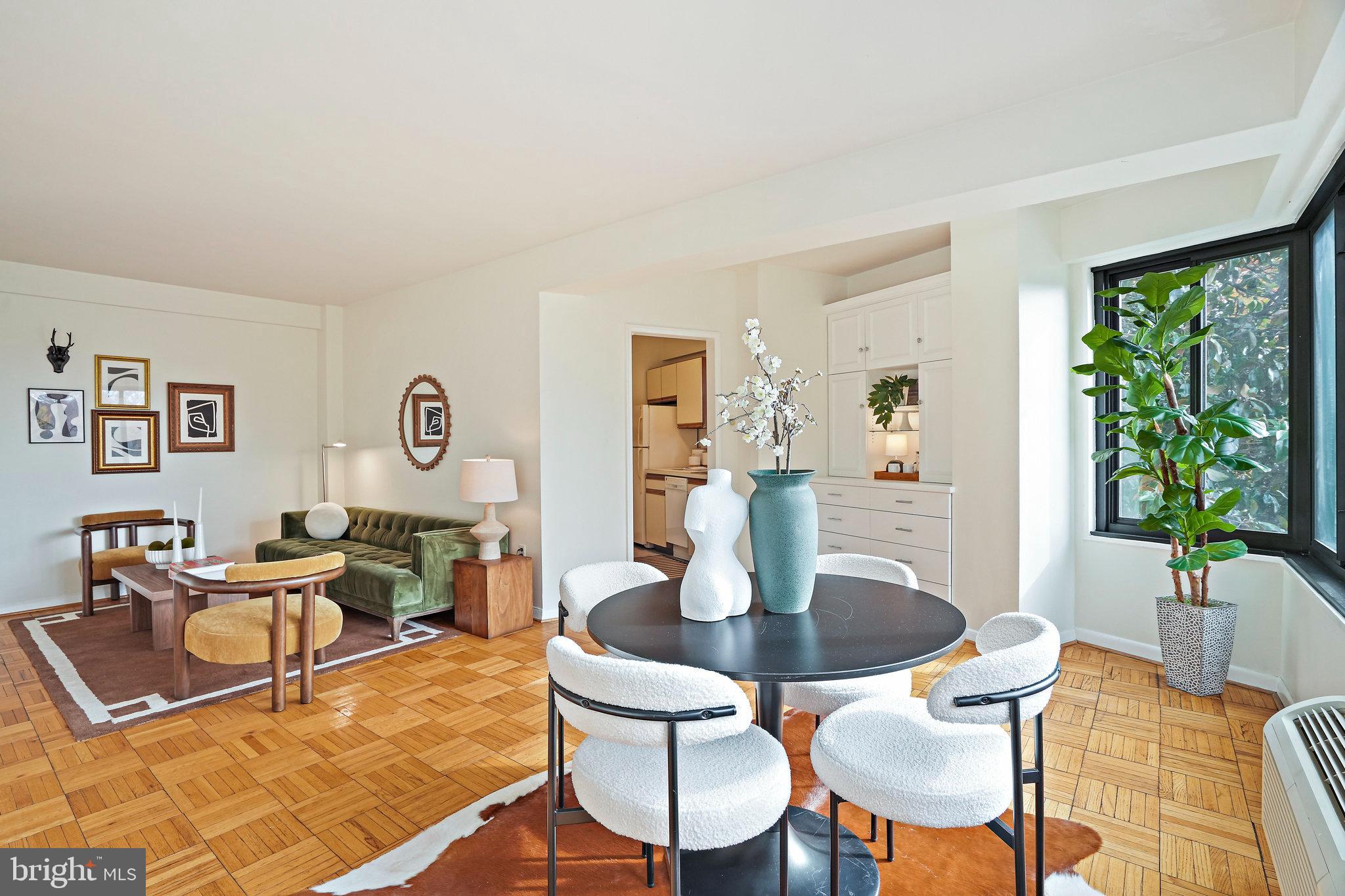3601 Wisconsin Avenue Northwest, Unit 204 Washington, DC 20016 - Photo 3 of 15 a dining room with wooden floor and a potted plant
