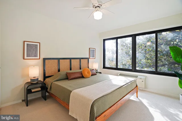 a bedroom with a large bed and a large window