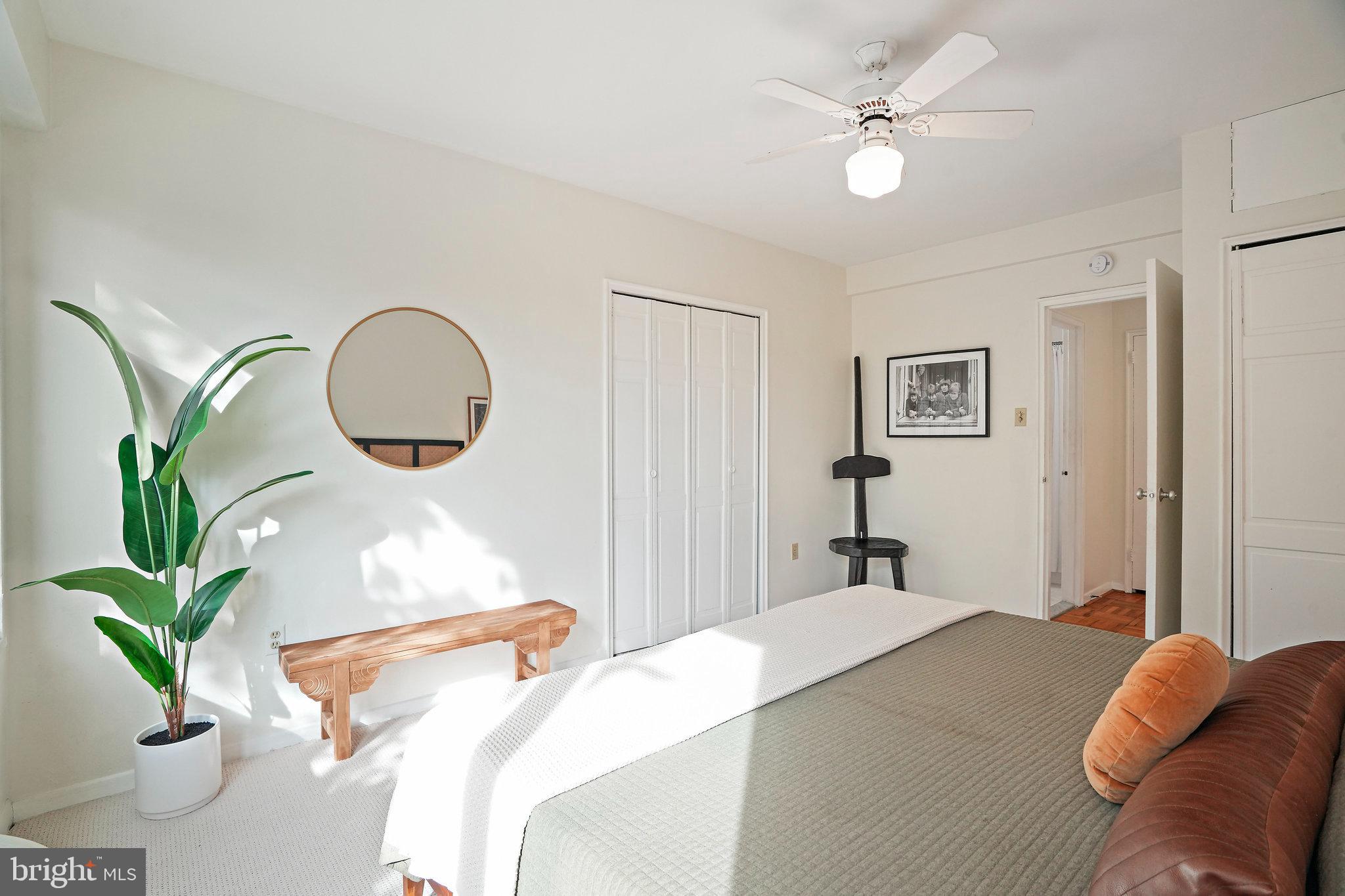 3601 Wisconsin Avenue Northwest, Unit 204 Washington, DC 20016 - Photo 9 of 15 a bedroom with bed and a potted plant