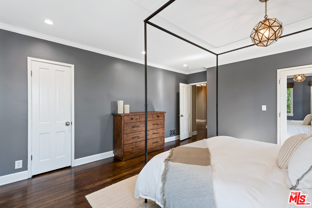 1307 South Rimpau Boulevard Los Angeles, CA 90019 - Photo 22 of 54 a bedroom with a bed and wooden floor