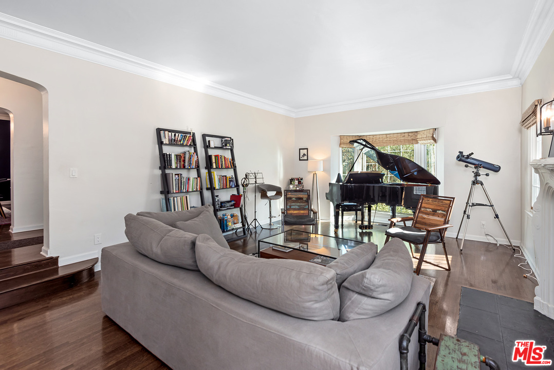 1307 South Rimpau Boulevard Los Angeles, CA 90019 - Photo 29 of 54 a living room with furniture and wooden floor