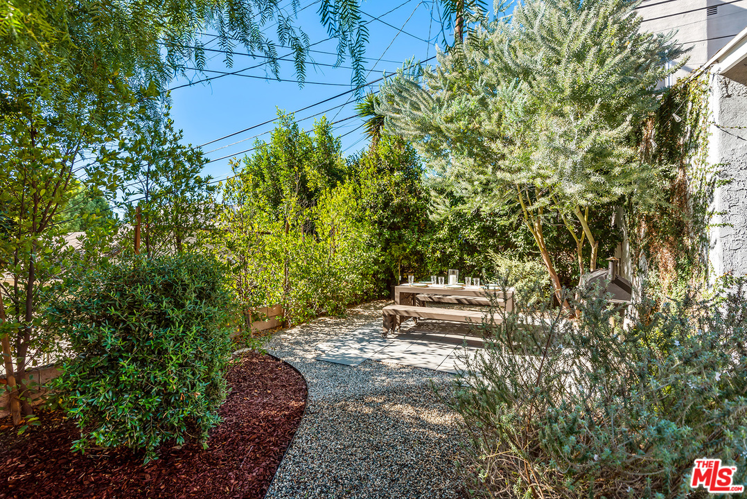 1307 South Rimpau Boulevard Los Angeles, CA 90019 - Photo 41 of 54 a view of a yard with plants and large trees