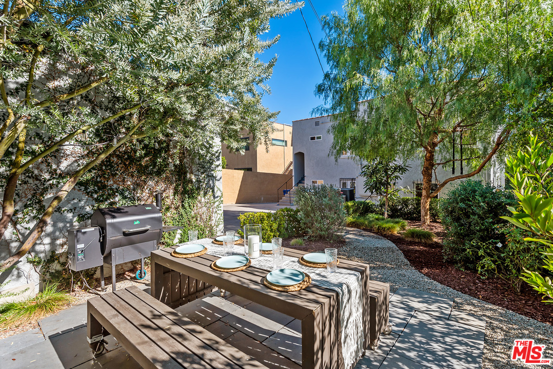 1307 South Rimpau Boulevard Los Angeles, CA 90019 - Photo 43 of 54 a view of a patio with table and chairs and potted plants