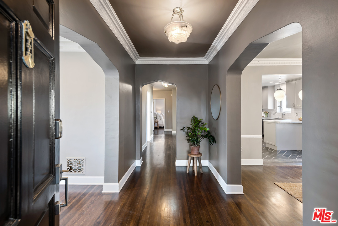 1307 South Rimpau Boulevard Los Angeles, CA 90019 - Photo 6 of 54 a view of a hallway view with wooden floor and a living room