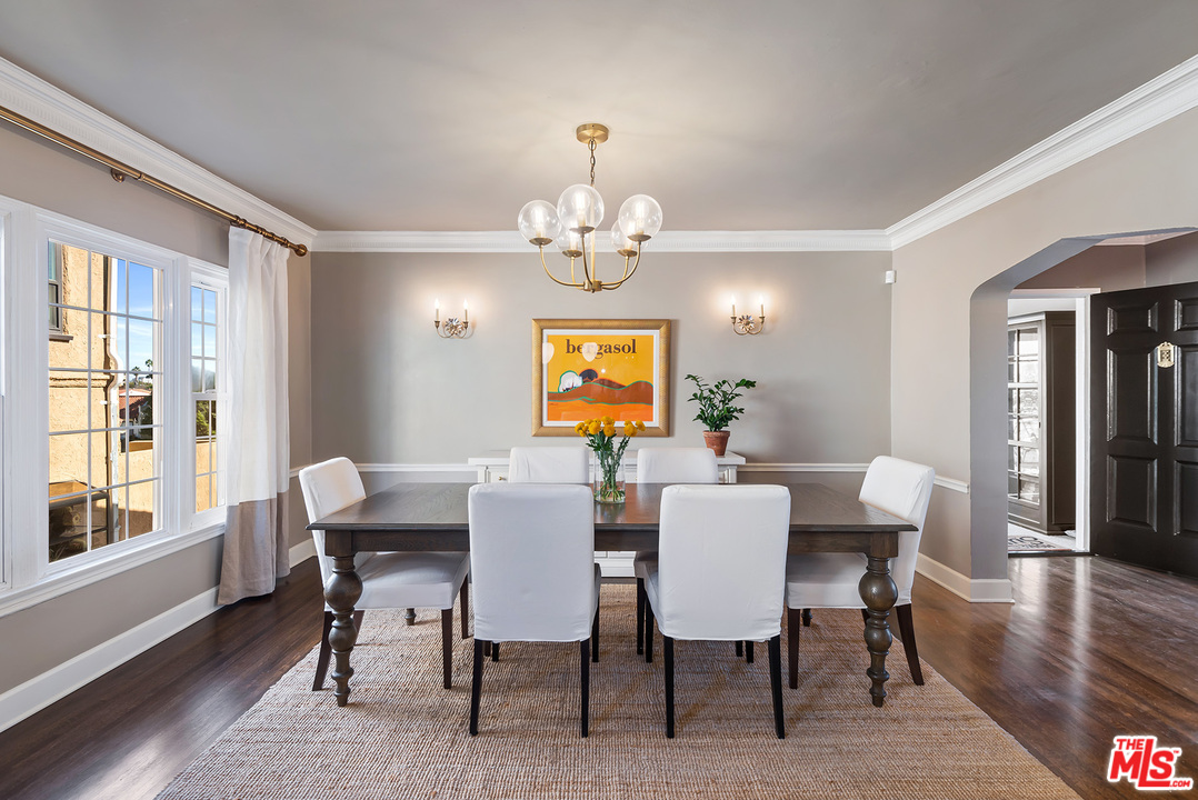 1307 South Rimpau Boulevard Los Angeles, CA 90019 - Photo 9 of 54 a view of a dining room with furniture wooden floor and chandelier