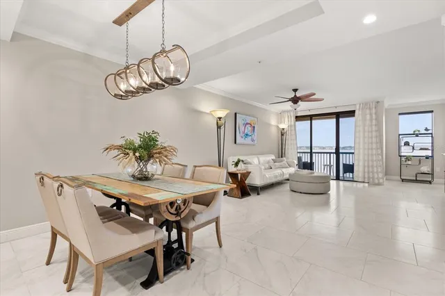 a view of a dining room with furniture wooden floor and chandelier