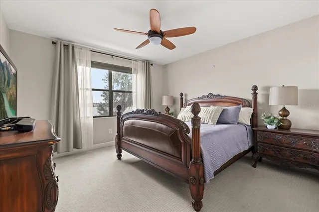 a spacious bedroom with a bed and a dresser next to a window