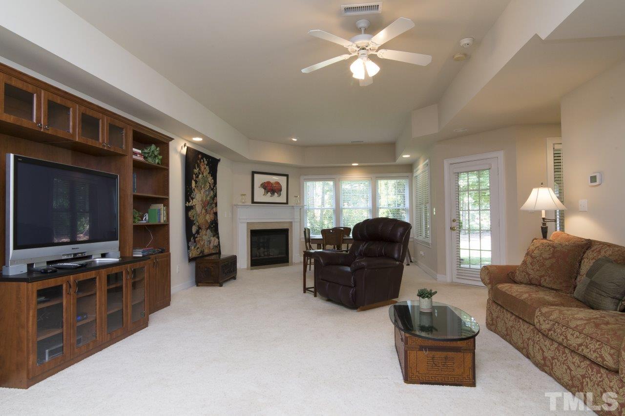 12301 Beestone Lane Raleigh, NC 27614 - Photo 21 of 25 a living room with furniture a flat screen tv and kitchen view