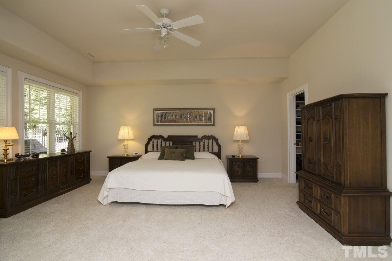 12301 Beestone Lane Raleigh, NC 27614 - Photo 23 of 25 a bedroom with a bed and dresser with mirror
