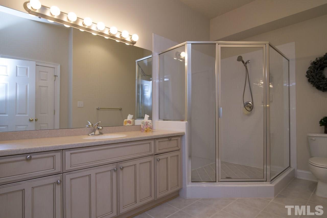12301 Beestone Lane Raleigh, NC 27614 - Photo 24 of 25 a bathroom with a double vanity sink mirror and shower