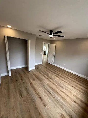 a view of a livingroom with a ceiling fan and wooden floor
