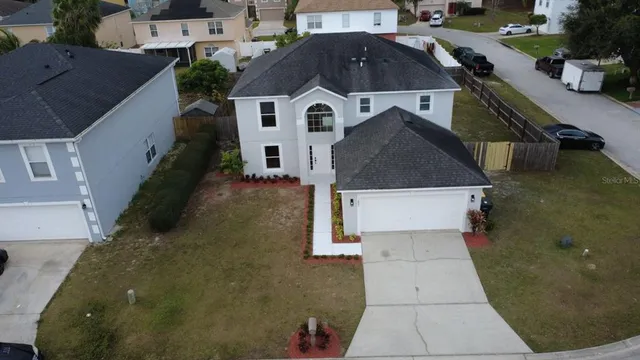 an aerial view of residential houses with outdoor space