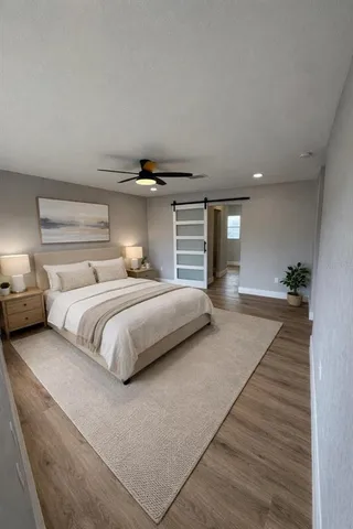 a bedroom with a large bed and potted plant