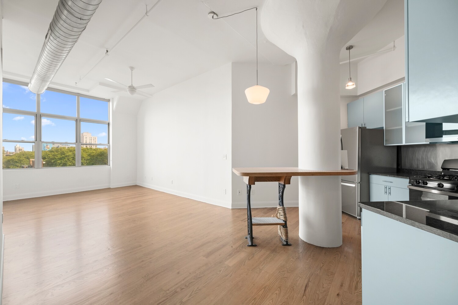 176 Johnson Street, Unit 7C Brooklyn, NY 11201 - Photo 10 of 15 a view of kitchen with stainless steel appliances granite countertop a stove top oven a sink and a refrigerator