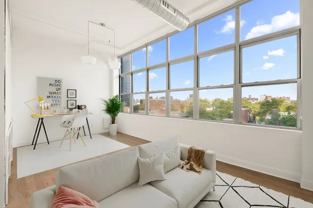 a living room with furniture kitchen view and a chandelier