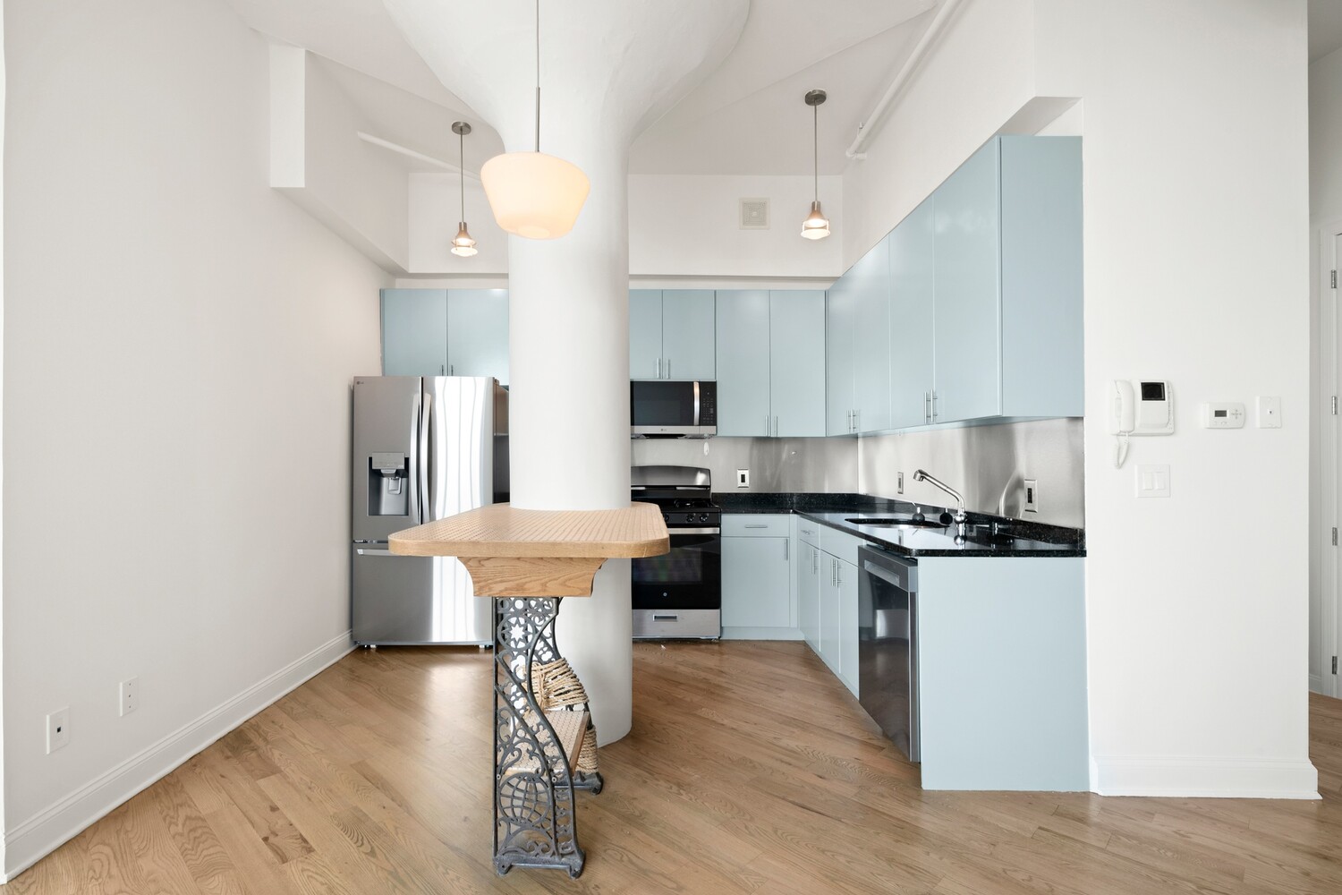 176 Johnson Street, Unit 7C Brooklyn, NY 11201 - Photo 6 of 15 a kitchen with stainless steel appliances granite countertop a stove a refrigerator a sink dishwasher and a dining table with wooden floor