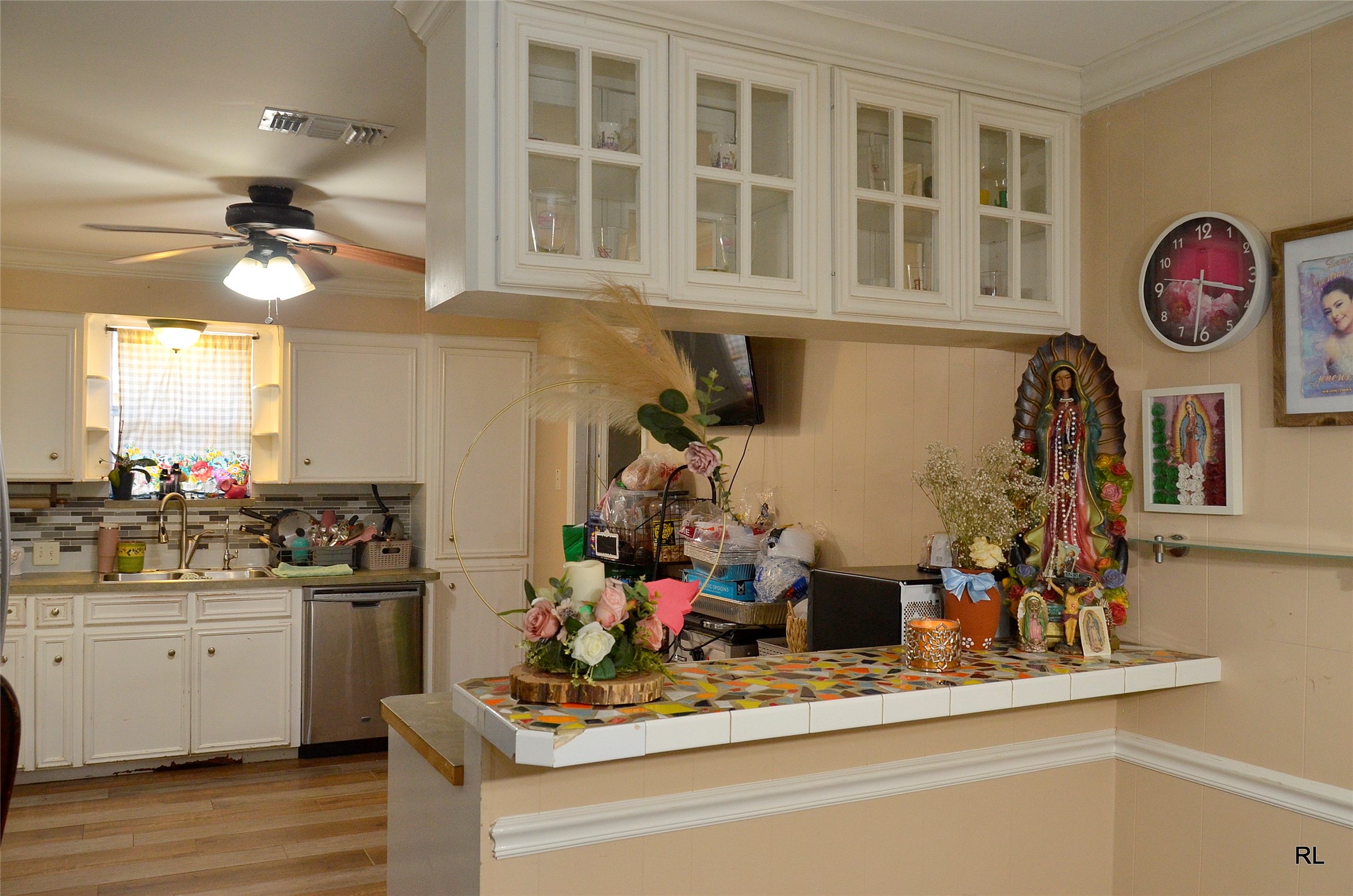 805 Avenue J Rosenberg, TX 77471 - Photo 8 of 22 a kitchen with a clock and cabinets